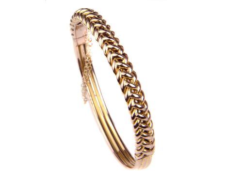 An antique yellow gold hollow entwined chevron link and tubular bangle, c1900, 10grms