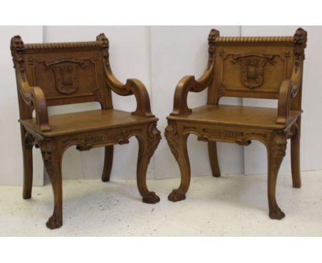 A pair of very fine quality late 19thC carved light oak armchairs, carved with scroll arms terminating in realistically carve