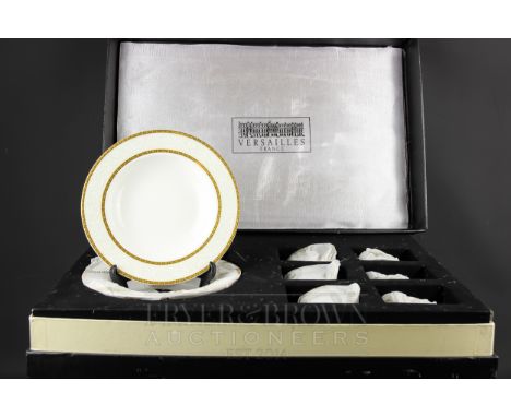 A Versailles, France, porcelain dinner service for six, decorated with gilt trellis borders with scrolling foliage between, c