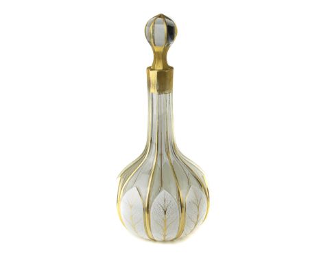 A Bohemian overlay glass decanter, of bottle form, the white casing cut through to colourless glass with leaf motifs, on a fa