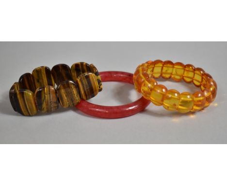 A Collection of Three Costume Jewellery Bracelets to Include Jade, Tigers Eye and Modern Amber 