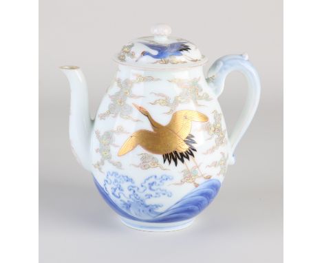 Antique Japanese porcelain teapot. Decorated with golden and blue cranes in clouds. With bottom mark. Circa 1890. Chip inner 