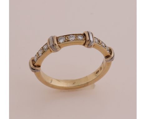 Yellow gold ring 585/000. Ring with 4 white gold double bars, slightly raised, between which are 3x3 brilliant cut diamonds, 