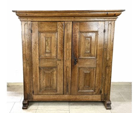 Antique German two-door spun cabinet made of oak, with sled legs and original lock. peasant baroque. Circa 1800. Dimensions: 