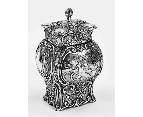 Silver tea caddy, 800/000. Contoured elongated model with cartouches depicting figures, further richly decorated with floral 