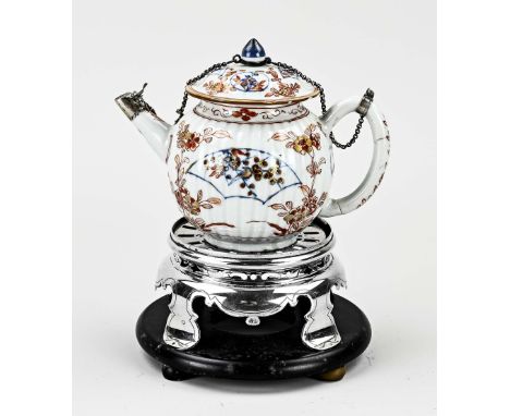 18th century Chinese Imari teapot with silver decoration, placed on a silver stove, round model with contoured edge with engr