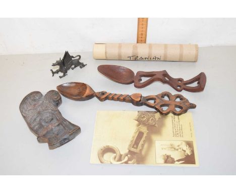 Two reproduction Welsh love spoons together with a carved figural press, a Welsh dragon model and an unframed caricature pict