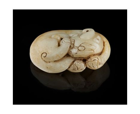 SMALL CELADON JADE CARVING OF A TIAN LUthe mythical beast with one antler shown recumbent with head turned backward, the ston