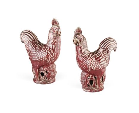 PAIR OF FLAMBÉ GLAZED PORCELAIN COCKERELSLATE QING DYNASTY each modelled standing on a pierced trunk-form base, with heads tu