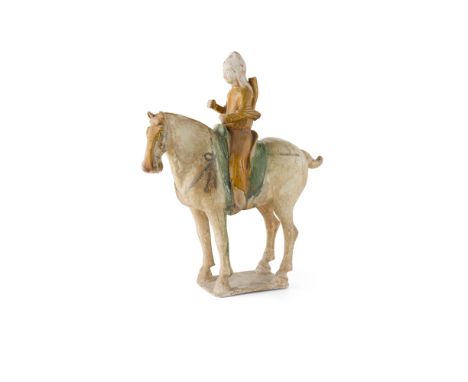 SANCAI GLAZED POTTERY FIGURE OF AN EQUESTRIAN ARCHERTANG DYNASTY the archer with hands raised as if holding a bow, carrying a