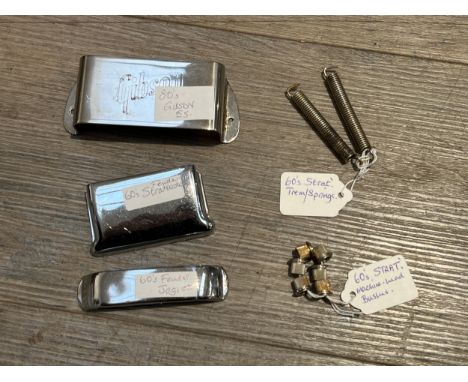 A quantity of Fender and Gibson guitar parts including machine head bushes and bridge covers