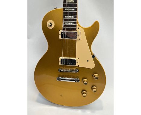 A circa 1973-75 Gibson USA Les Paul Deluxe model 'Gold Top' electric guitar, serial number 898859, wear consistent with age, 
