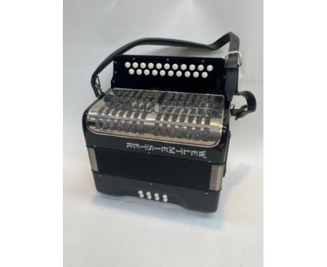 A Weltmeister accordion, cased