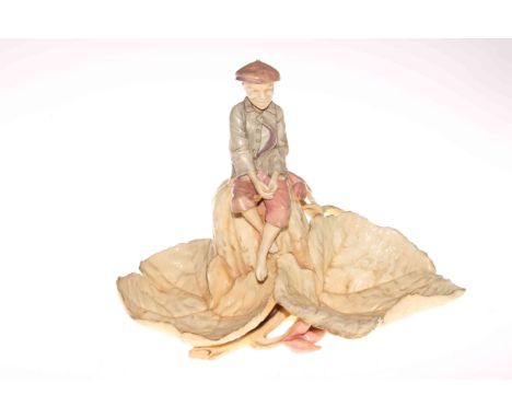 Pottery model of boy on leaves painted HMC mark to base.