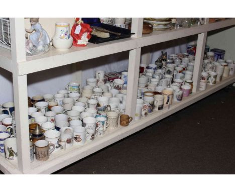 Full shelf of commemorative mugs and tins, etc.