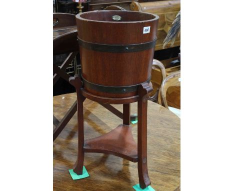 Circular brass bound planter on stand bearing label for Imperial, Bristol, 71cm by 31cm diameter.