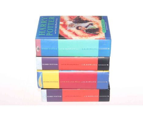 Four Harry Potter First Edition books.