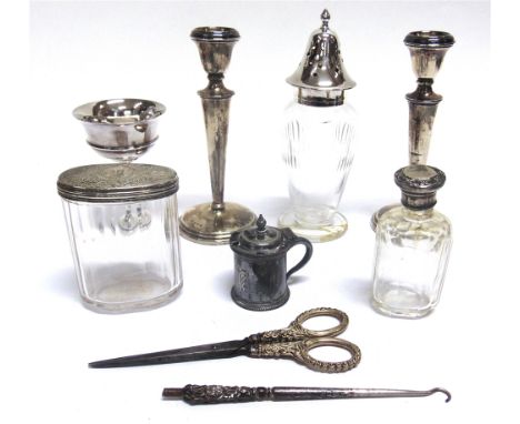 A PAIR OF LOADED SILVER CANDLESTICKS by William Neale, Birmingham 1908, 15.8cm high; with a late Victorian silver salt spoon;