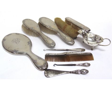 A SILVER SAUCEBOAT of small size, with cut rim, 13.5cm long, 60g (1.9 troy ozs) gross; with a silver dressing table set, comp