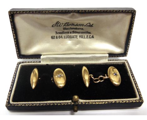 A PAIR OF DIAMOND SET CUFFLINKS stamped '18', the oval panel star set with an old cut diamond, totalling approximately 0.1 ca