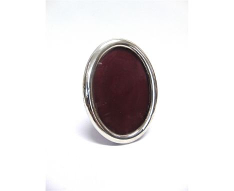 A LATE VICTORIAN SILVER OVAL PHOTOGRAPH FRAME Birmingham 1898, the plain border 16cm by 12cm, image area 13cm by 9cm, leather