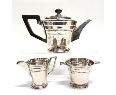 A SILVER THREE PIECE ART DECO TEA SERVICE by Walker & Hall, Sheffield 1943, of tapering stepped form, 1069g (34.4 troy ozs) g