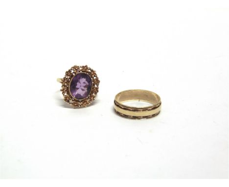 A 9 CARAT GOLD SINGLE STONE AMETHYST RING  and a 9 carat gold wedding ring; 5.1g gross