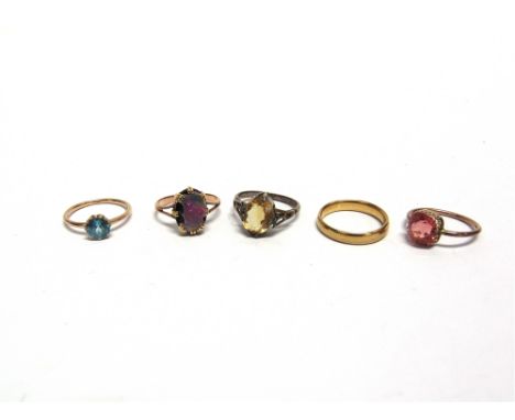 A 22 CARAT GOLD WEDDING RING  4.5g gross; an opal doublet ring; a blue zircon single stone ring; and two paste rings 