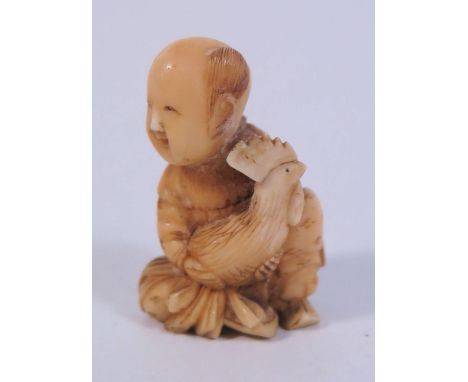 An Antique Japanese Ivory Netsuke of a seated figure holding cockerel UK BIDS ONLY