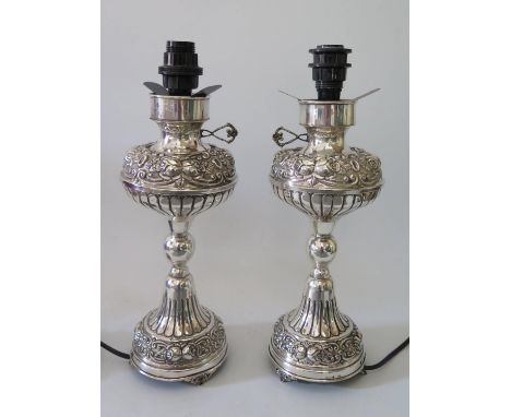 A Pair of Continental Sterling Silver Lamp Bases with foliate scroll and rose decoration comma 29cm 1480 g gross 