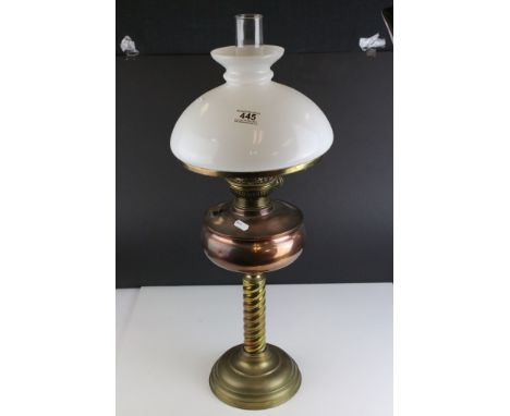 An early 20th century brass and copper oil lamp complete with glass shade and chimney. 