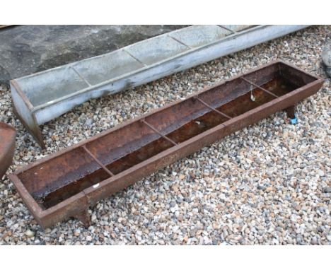 A vintage cast iron free standing water / food trough, measures approx 153cm 