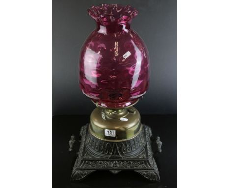 Large Victorian Brass Oil Lamp with Dimpled Cranberry Glass Shade and held on a Large Square Cast Iron Base, 56cms high 