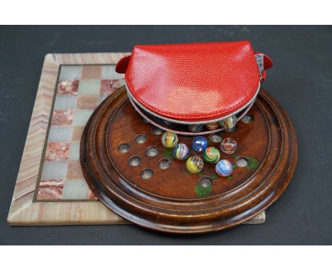 A wooden solitaire board complete with vintage marbles together with an agate chess board. 