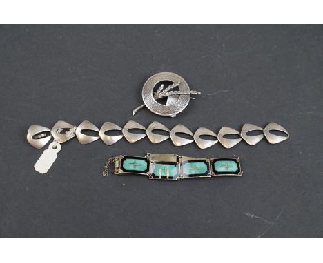 A collection of sterling silver mid century jewellery to include a scottish silver brooch and two Scandinavian braclets to in