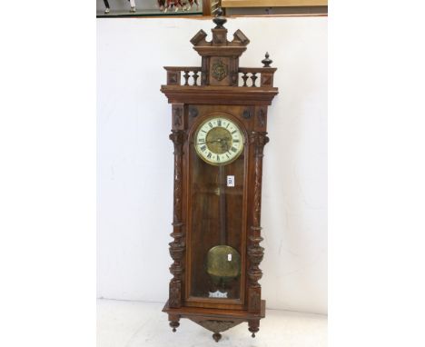 A antique Vienna style drop dial twin train movement wall clock with brass weights.