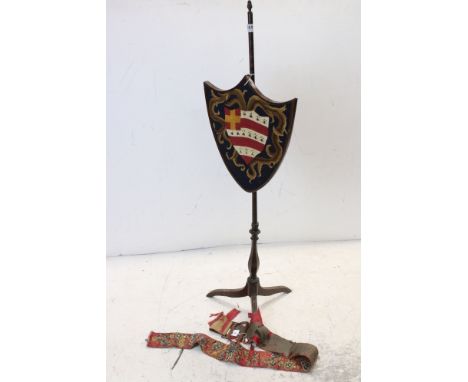 19th century mahogany and box strung pole screen, with shield shaped screen inset with hand stitched armorial, tripod base, a