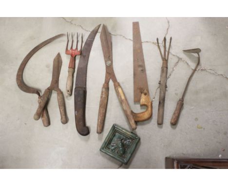 A small group of vintage gardening tools to include shears and saws. 