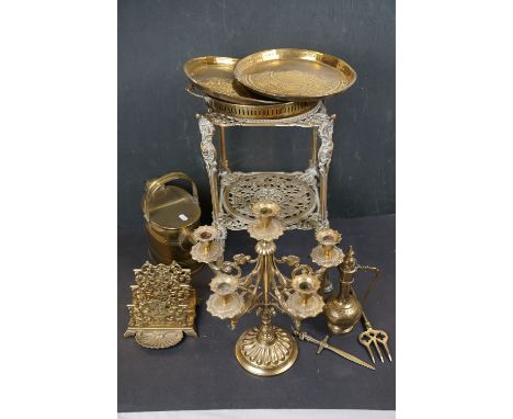 A collection of assorted brass ware to include candlestick, letter rack and a watering can. 