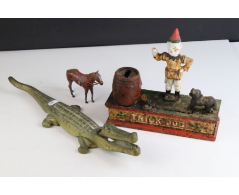 A vintage "Trick Dog" wrought iron money box together with a brass Crocodile nutcracker. 