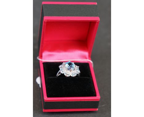 Silver and blue topaz dress ring set with CZs, stamped 925 