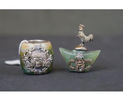 A vintage Tibetan jade ring with white metal mount together with another similar. 