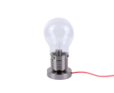 A contemporary retro table lamp. In the form of an Edison light bulb on a circular metal base. H27cm