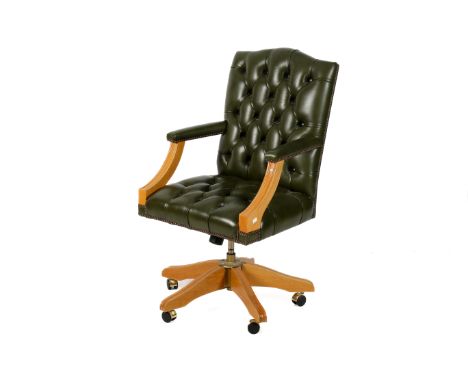 A dark green leather upholstered button back office swivel chair with light oak frame and base on large castors. Leather work