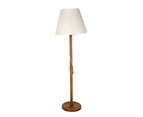 1960's period teak standard lamp. Having a turned column raised on a circular base. H147cm
