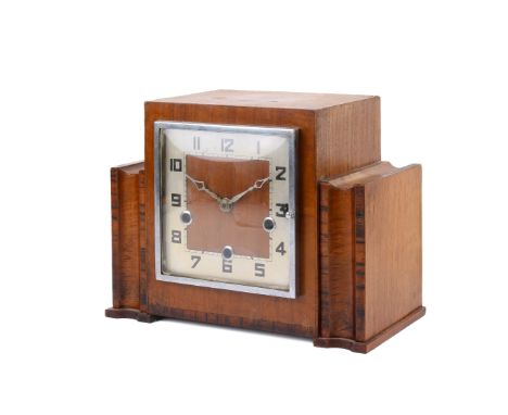 An Art Deco period walnut and crossbanded striking and chiming mantel clock. Having a square chapter ring Arabic numerals. Pe