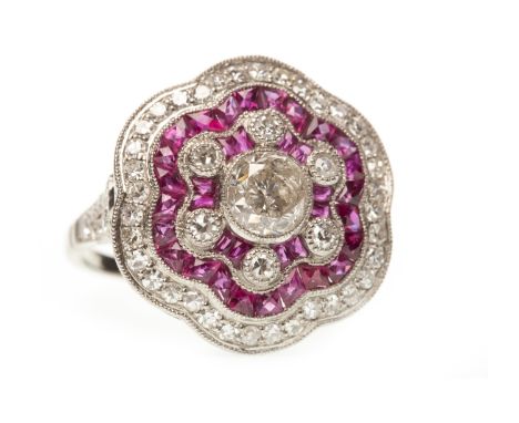 RUBY AND DIAMOND RING, the central diamond of approximately 0.80 carats, surrounded by calibre cut rubies totalling approxima