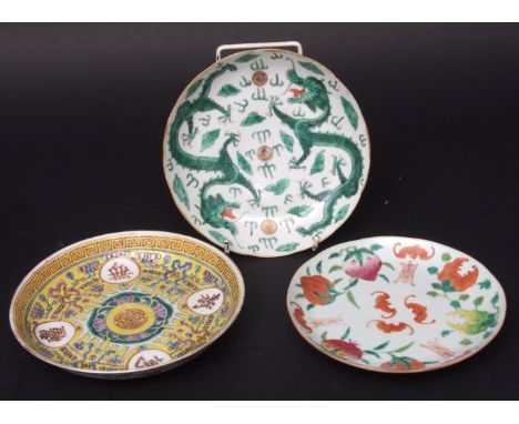 Three Chinese porcelain dishes, the first a yellow ground example with gilt character roundels (Guangxu iron red mark), the s