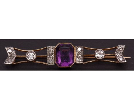 Edwardian cased yellow metal open work bar brooch (unmarked), featuring a large shaped octagonal amethyst (90mm x 80mm) flank