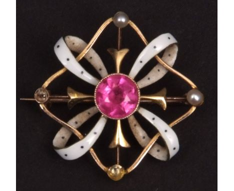 Edwardian yellow metal open work brooch, set to the centre with a bright pink stone and flanked by loops of white enamel stra
